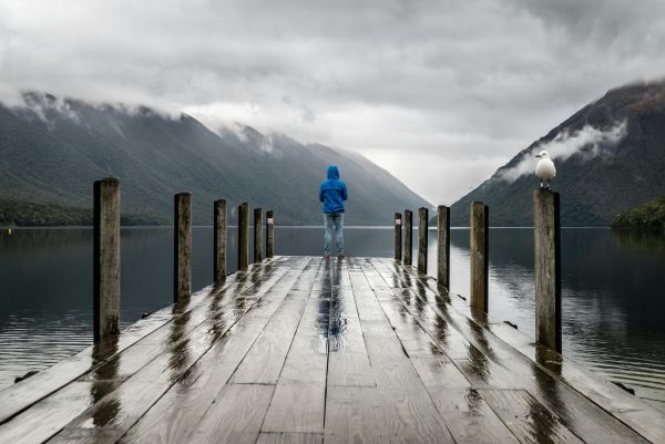 Person standing on a dock after a rainstorm